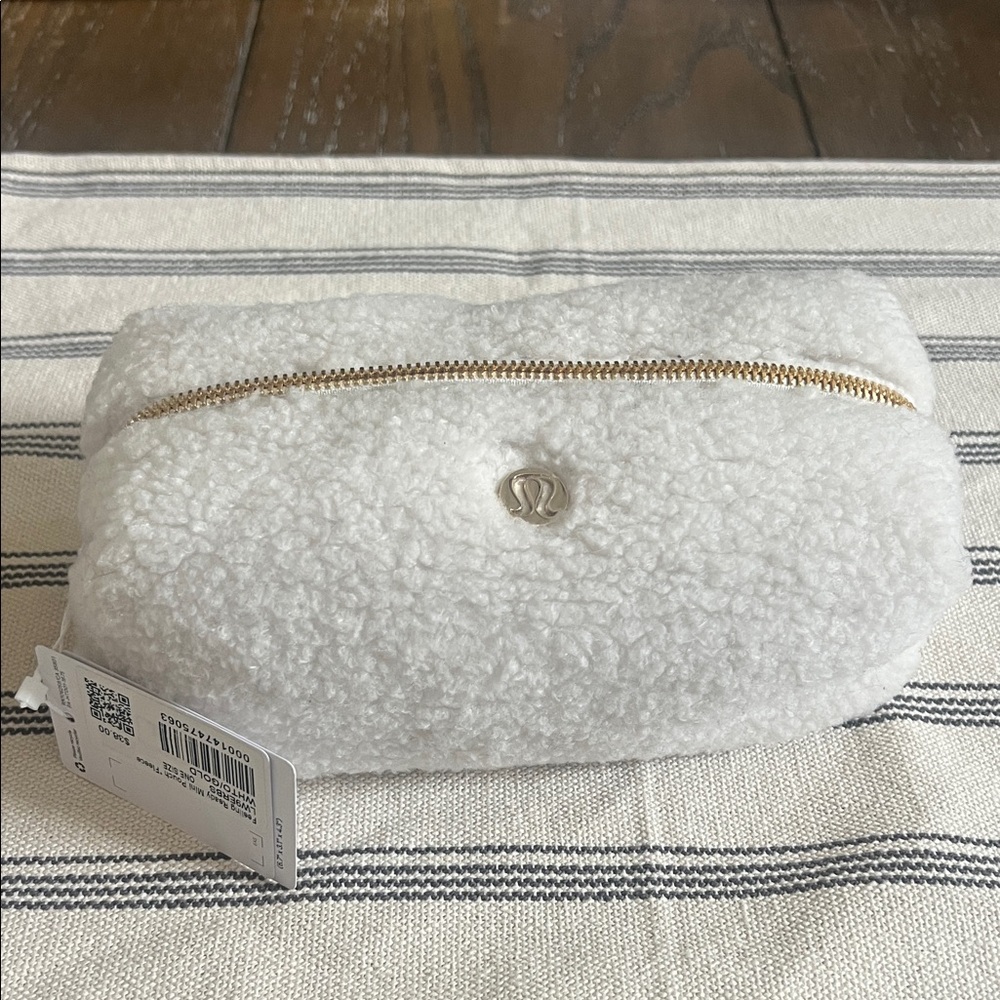 Lululemon Athletica White and Gold Fleece mini pouch